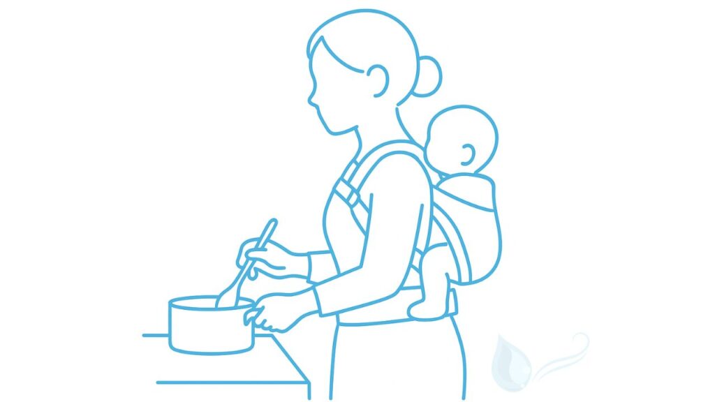 母親が台所で料理をしながら背中に赤ちゃんをおんぶしているイラスト。おんぶタイプの抱っこ紐の使用シーン。